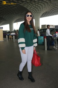 Actress Laxmi Raai in a green sweater at Mumbai Airport