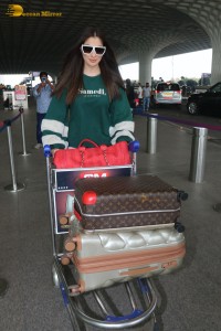 Actress Laxmi Raai in a green sweater at Mumbai Airport
