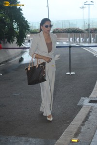 bollywood actress Madhuri Dixit spotted in white pantsuit at airport