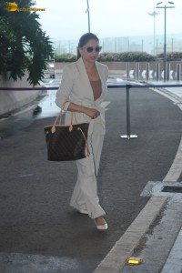 bollywood actress Madhuri Dixit spotted in white pantsuit at airport