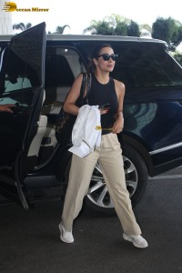 malaika arora in sunglasses and stylish attire at airport