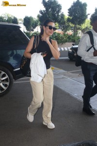 malaika arora in sunglasses and stylish attire at airport