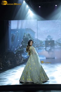 bollywood actress Malaika Arora ramp walk in a green lehenga choli dress