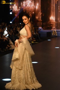 actress malaika arora stunning in a yellow dress doing a ramp walk