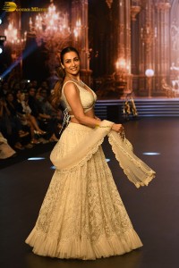 actress malaika arora stunning in a yellow dress doing a ramp walk