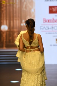 actress malaika arora stunning in a yellow dress doing a ramp walk