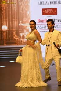 actress malaika arora stunning in a yellow dress doing a ramp walk