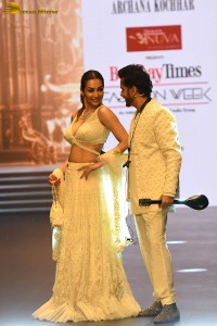 actress malaika arora stunning in a yellow dress doing a ramp walk