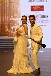 actress malaika arora stunning in a yellow dress doing a ramp walk
