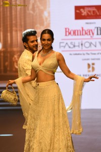 actress malaika arora stunning in a yellow dress doing a ramp walk