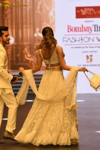 actress malaika arora stunning in a yellow dress doing a ramp walk