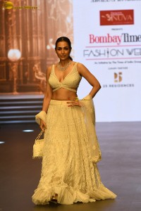 actress malaika arora stunning in a yellow dress doing a ramp walk