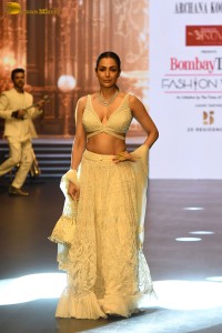 actress malaika arora stunning in a yellow dress doing a ramp walk