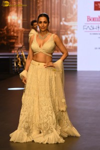 actress malaika arora stunning in a yellow dress doing a ramp walk