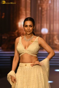 actress malaika arora stunning in a yellow dress doing a ramp walk
