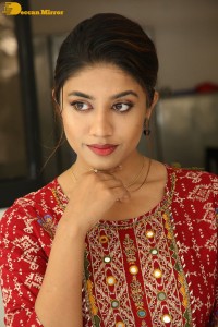 Actress Malavika Satheesan in a red dress