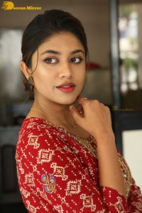 Actress Malavika Satheesan in a red dress