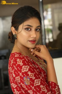 Actress Malavika Satheesan in a red dress