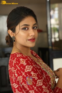Actress Malavika Satheesan in a red dress