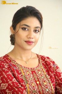 Actress Malavika Satheesan in a red dress