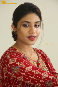 Actress Malavika Satheesan in a red dress