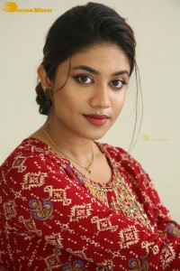 Actress Malavika Satheesan in a red dress