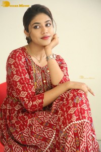 Actress Malavika Satheesan in a red dress