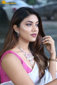 Actress Malavika Satheesan in a white saree