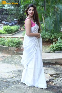Actress Malavika Satheesan in a white saree