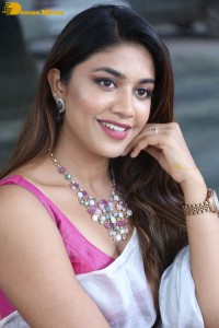 Actress Malavika Satheesan in a white saree