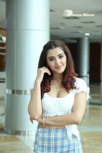 Actress Malvika Sharma Photogallery in white top and checks miniskirt