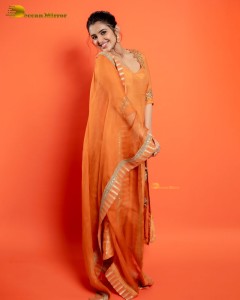Actress Malvika Sharma in a orange salwar dress