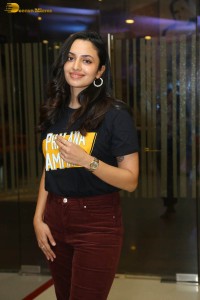 actress malvika nair in a black t-shirt and red pants
