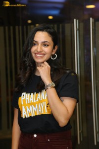 actress malvika nair in a black t-shirt and red pants