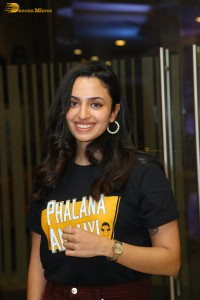 actress malvika nair in a black t-shirt and red pants