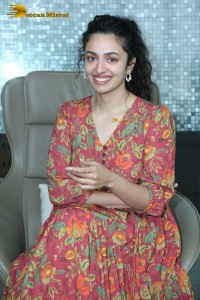 Actress malvika nair in a red colorful dress looking cute