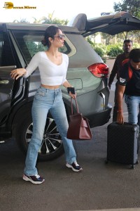 miss universe manushi chhillar in a white top and blue denim jeans