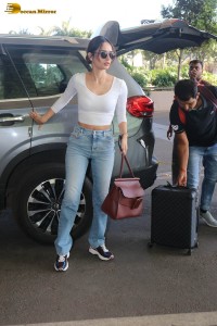 miss universe manushi chhillar in a white top and blue denim jeans