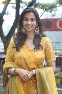 Indian actress meenakshi chaudhary in a yellow dress