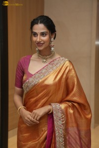 Indian actress Meenakshi Chaudhary dazzles in a yellow gold color saree at a function