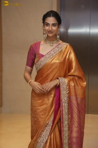 Indian actress Meenakshi Chaudhary dazzles in a yellow gold color saree at a function