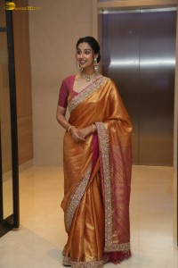 Indian actress Meenakshi Chaudhary dazzles in a yellow gold color saree at a function
