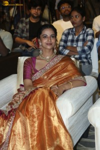 Indian actress Meenakshi Chaudhary dazzles in a yellow gold color saree at a function
