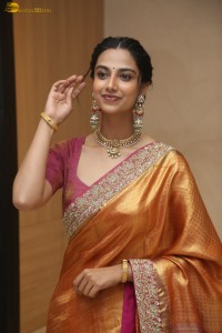 Indian actress Meenakshi Chaudhary dazzles in a yellow gold color saree at a function