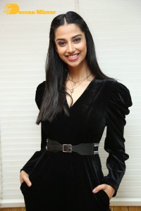Meenakshi Chaudhary in a black pantsuit dress