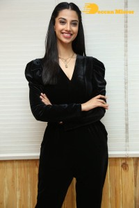 Meenakshi Chaudhary in a black pantsuit dress