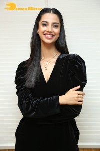 Meenakshi Chaudhary in a black pantsuit dress