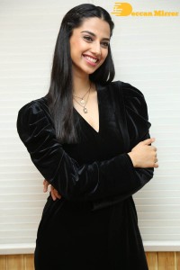 Meenakshi Chaudhary in a black pantsuit dress