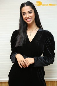 Meenakshi Chaudhary in a black pantsuit dress