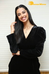 Meenakshi Chaudhary in a black pantsuit dress